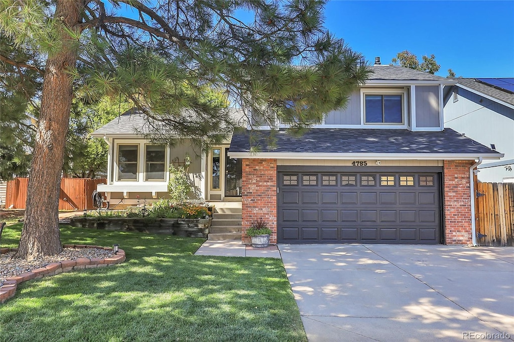 view of front of property with a front yard and a garage