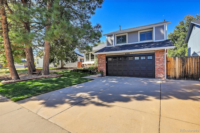 view of front of property with a garage and a front yard