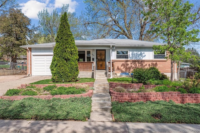 6882 Moore St, Arvada, CO 80004 - single story home with brick siding, driveway, a garage, and fence