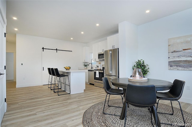 dining area featuring light hardwood / wood-style flooring and sink