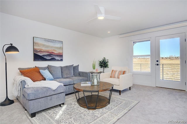 living room with ceiling fan and light carpet