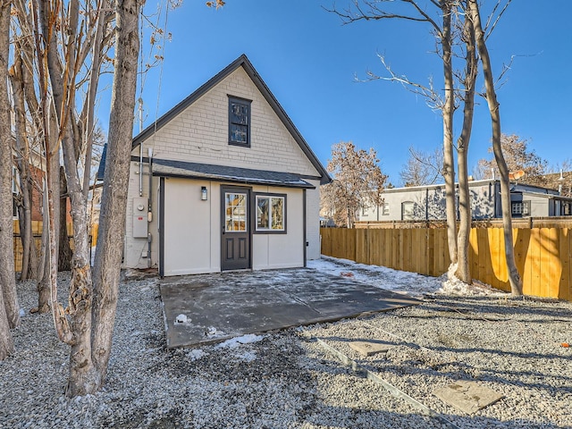 rear view of property with a patio area and fence