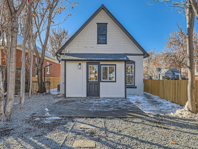 rear view of house featuring a patio, central AC, and fence