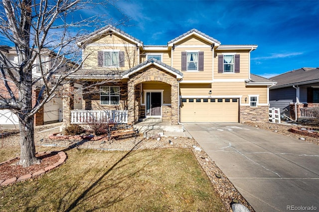 view of front of house with a garage, a porch, and a front yard