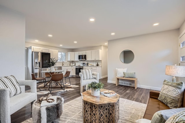 living room with dark wood-type flooring and sink