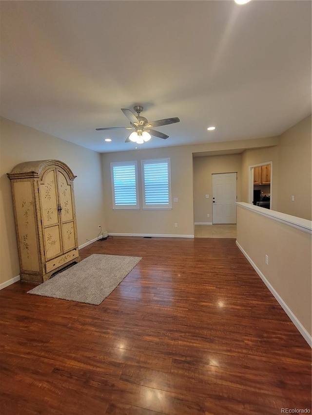 1431 4th Pl, Deer Trail, CO 80105 - unfurnished living room with a ceiling fan, baseboards, wood finished floors, and recessed lighting