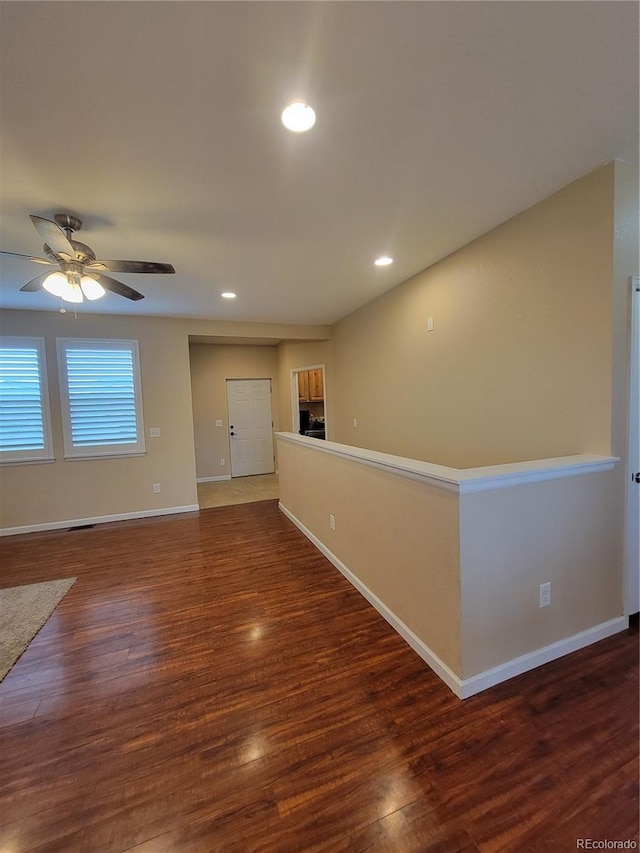 1431 4th Pl, Deer Trail, CO 80105 - unfurnished room with wood finished floors, baseboards, a ceiling fan, and recessed lighting