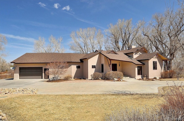 1100 Pinon Dr, Poncha Springs, CO 81242 - view of front of property with concrete driveway, roof with shingles, stucco siding, a chimney, and an attached garage
