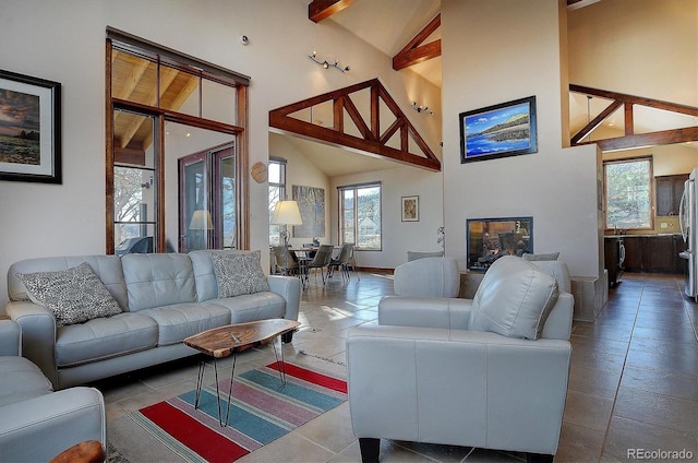 1100 Pinon Dr, Poncha Springs, CO 81242 - living area featuring beamed ceiling, a wealth of natural light, and high vaulted ceiling