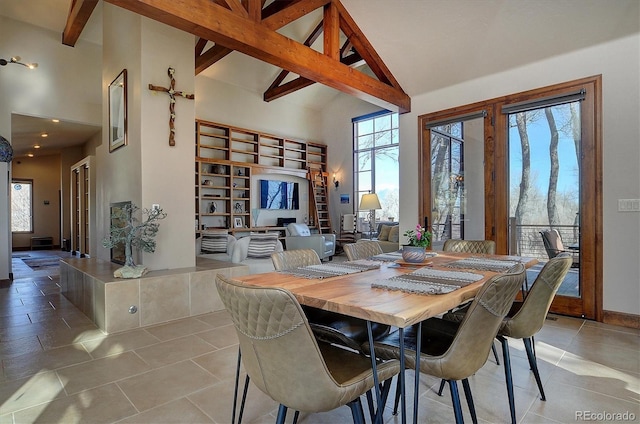 1100 Pinon Dr, Poncha Springs, CO 81242 - tiled dining area featuring beam ceiling, a wealth of natural light, and high vaulted ceiling