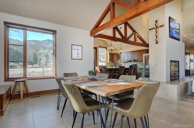 1100 Pinon Dr, Poncha Springs, CO 81242 - dining space with high vaulted ceiling, a wealth of natural light, light tile patterned floors, and an inviting chandelier
