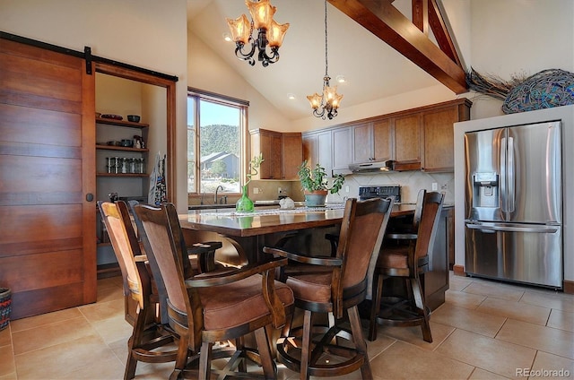 1100 Pinon Dr, Poncha Springs, CO 81242 - dining area featuring a chandelier, light tile patterned floors, and high vaulted ceiling