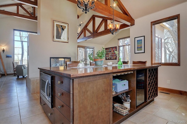 1100 Pinon Dr, Poncha Springs, CO 81242 - kitchen with visible vents, stainless steel microwave, plenty of natural light, and a notable chandelier