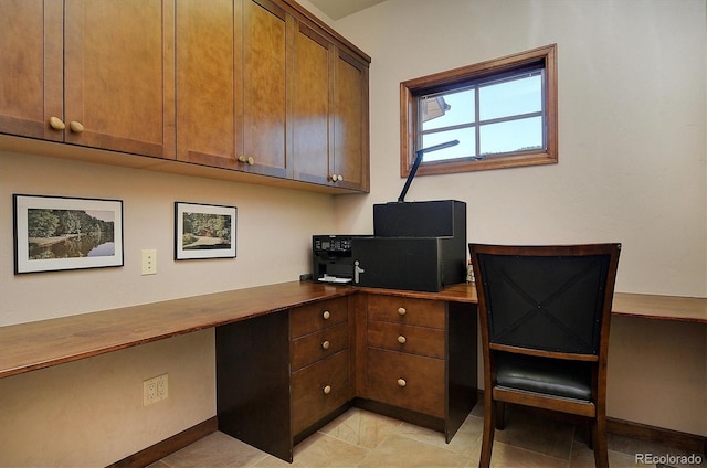 1100 Pinon Dr, Poncha Springs, CO 81242 - office area featuring built in desk, light tile patterned flooring, and baseboards