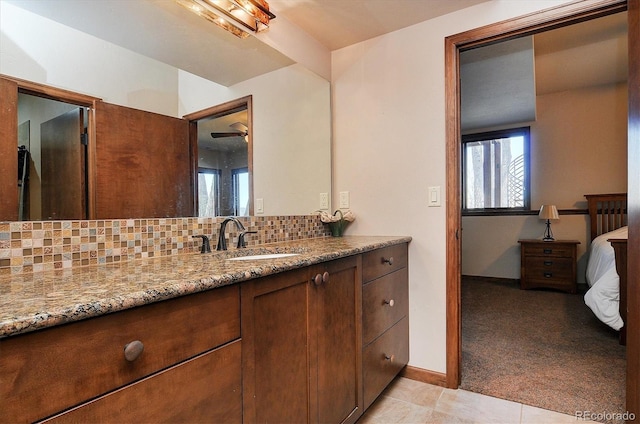 1100 Pinon Dr, Poncha Springs, CO 81242 - ensuite bathroom featuring tile patterned floors, decorative backsplash, ensuite bathroom, and vanity