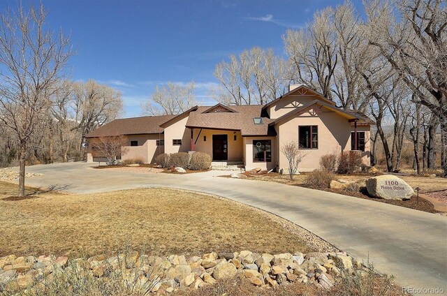 1100 Pinon Dr, Poncha Springs, CO 81242 - ranch-style home with roof with shingles, stucco siding, and curved driveway