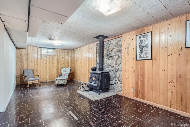 interior space featuring wood walls and a wood stove