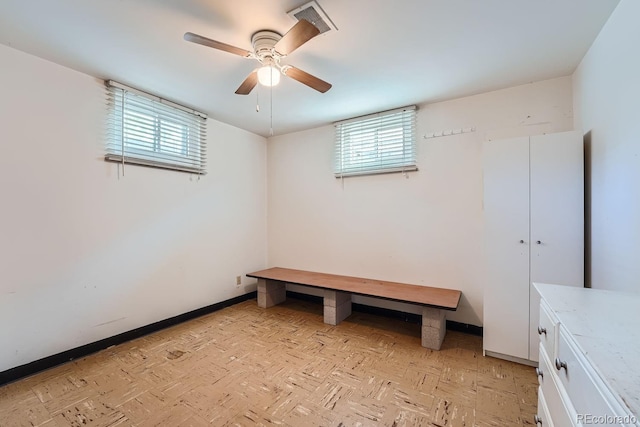 interior space with ceiling fan