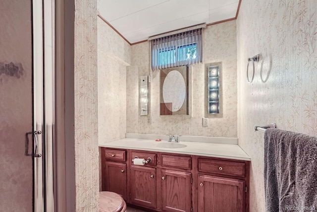bathroom featuring crown molding, vanity, and toilet