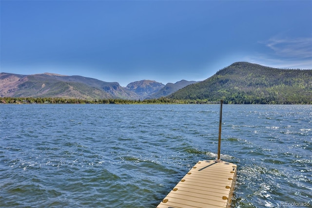 view of dock featuring a water and mountain view