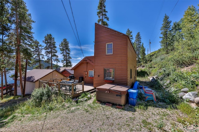 rear view of property with a wooden deck