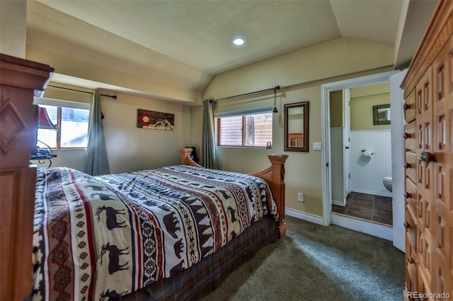 carpeted bedroom featuring connected bathroom and lofted ceiling