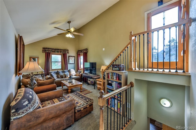 carpeted living room with high vaulted ceiling and ceiling fan