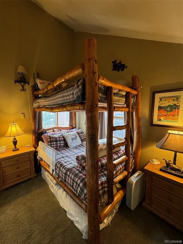 carpeted bedroom with lofted ceiling