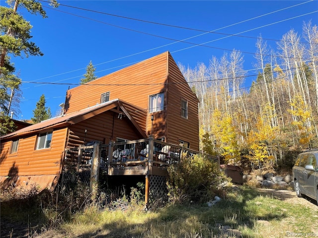 back of property with a wooden deck