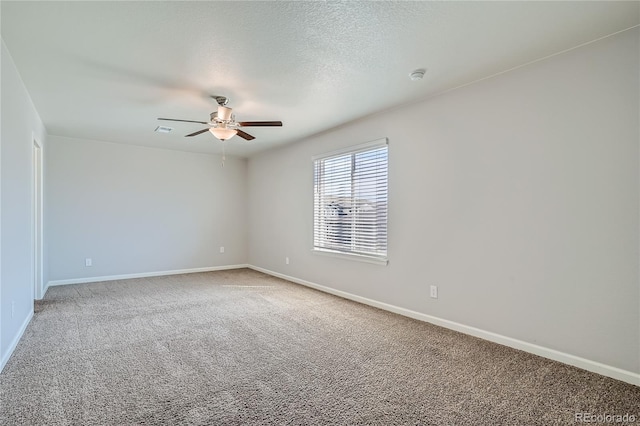 carpeted spare room featuring a textured ceiling and ceiling fan