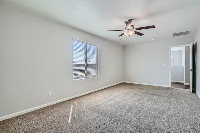 carpeted empty room featuring ceiling fan