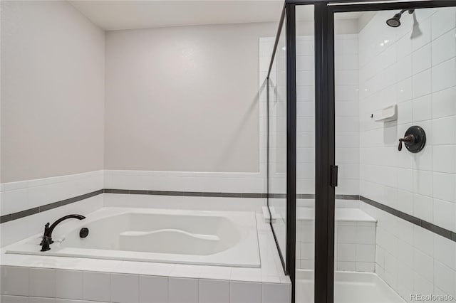 bathroom featuring shower with separate bathtub