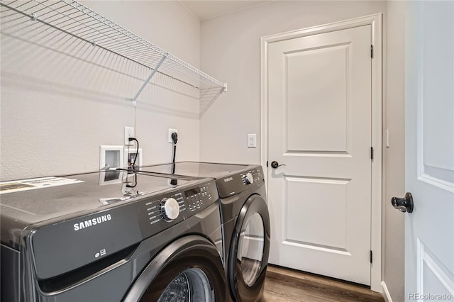 laundry area featuring hardwood / wood-style floors and separate washer and dryer