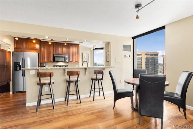 1625 Larimer St Unit 1605, Denver, CO 80202 - dining room with light wood-style floors and baseboards