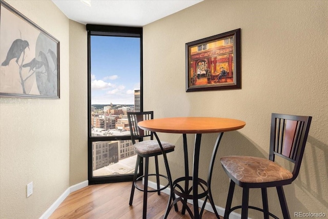 1625 Larimer St Unit 1605, Denver, CO 80202 - dining space featuring wood finished floors and a textured wall