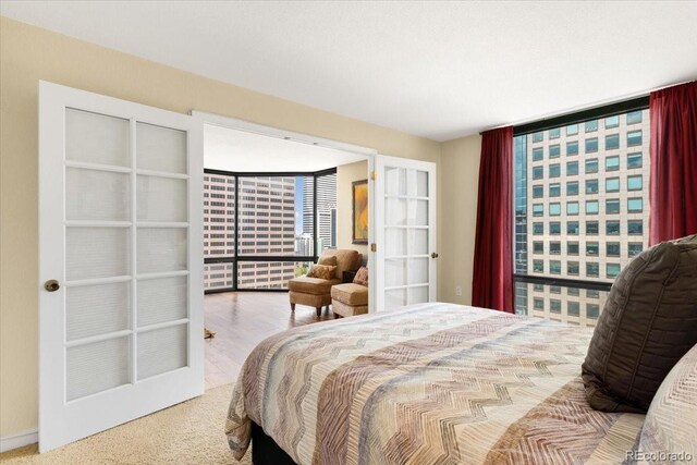 1625 Larimer St Unit 1605, Denver, CO 80202 - bedroom featuring floor to ceiling windows, french doors, and carpet