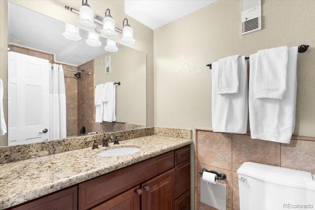 1625 Larimer St Unit 1605, Denver, CO 80202 - full bath featuring vanity, a shower with curtain, and tile walls