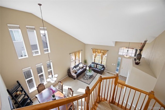 13078 Monaco Way, Thornton, CO 80602 - carpeted living area with a chandelier, baseboards, and high vaulted ceiling