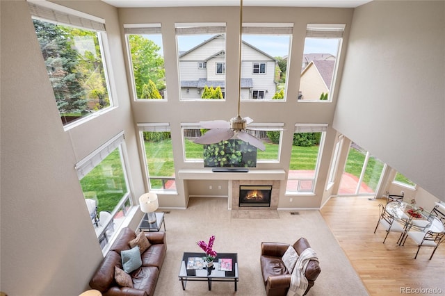 13078 Monaco Way, Thornton, CO 80602 - living room with a towering ceiling, a tile fireplace, and wood finished floors
