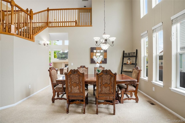 13078 Monaco Way, Thornton, CO 80602 - dining area featuring a chandelier, a towering ceiling, healthy amount of natural light, and carpet flooring