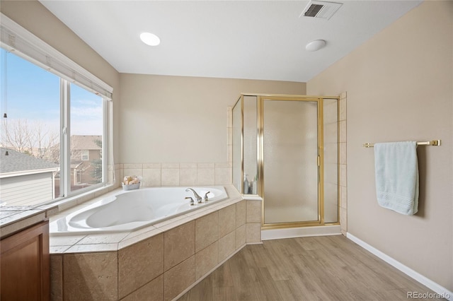 13078 Monaco Way, Thornton, CO 80602 - full bath with a stall shower, wood finished floors, a bath, and baseboards