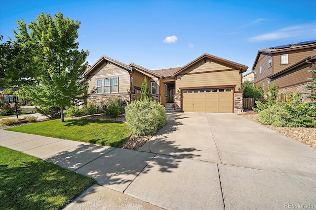 23871 E Ontario Pl, Aurora, CO 80016 - view of front of house featuring stone siding, an attached garage, a front yard, and concrete driveway