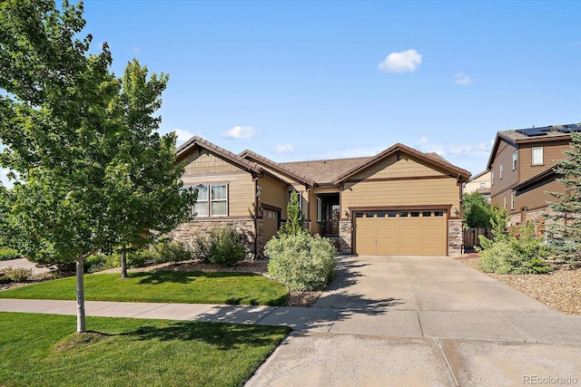 23871 E Ontario Pl, Aurora, CO 80016 - view of front of home with stone siding, a front yard, a garage, and driveway
