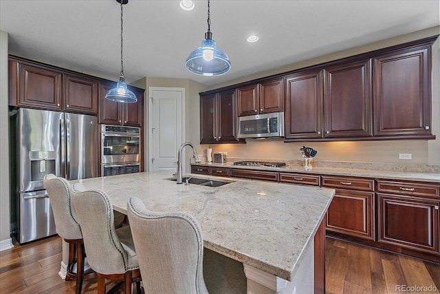 23871 E Ontario Pl, Aurora, CO 80016 - kitchen featuring appliances with stainless steel finishes, dark wood-style floors, light stone counters, hanging light fixtures, and recessed lighting