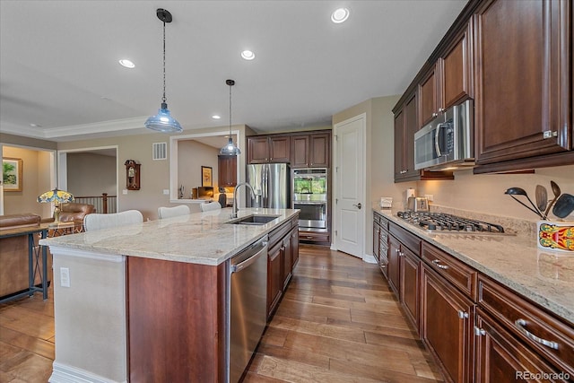 23871 E Ontario Pl, Aurora, CO 80016 - kitchen featuring appliances with stainless steel finishes, dark wood finished floors, light stone countertops, recessed lighting, and open floor plan