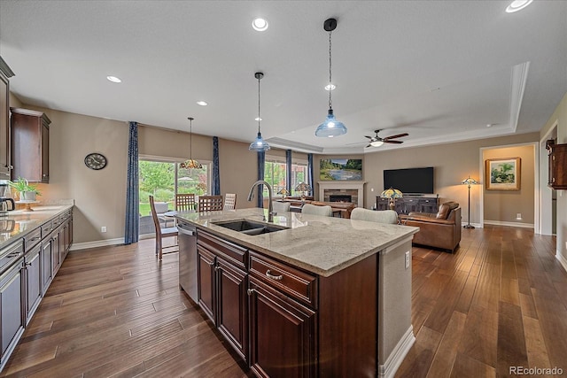 23871 E Ontario Pl, Aurora, CO 80016 - kitchen featuring a ceiling fan, dishwasher, a fireplace, a raised ceiling, and dark wood-style floors
