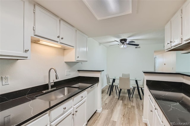 kitchen with white cabinetry, white dishwasher, ceiling fan, light hardwood / wood-style floors, and sink