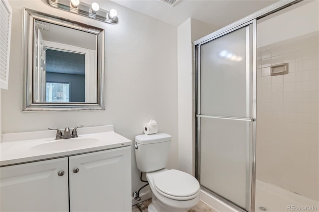 bathroom with tile patterned floors, toilet, vanity, and an enclosed shower