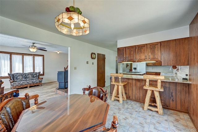 tiled dining area featuring ceiling fan