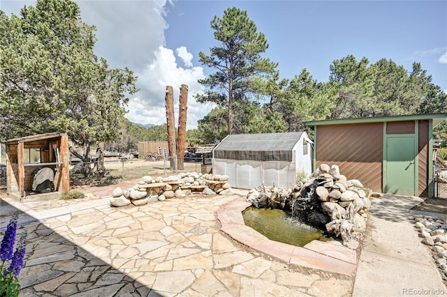 view of patio with an outbuilding